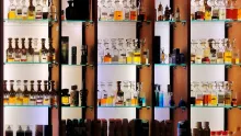 Étagères éclairées remplies de flacons de parfum de formes variées